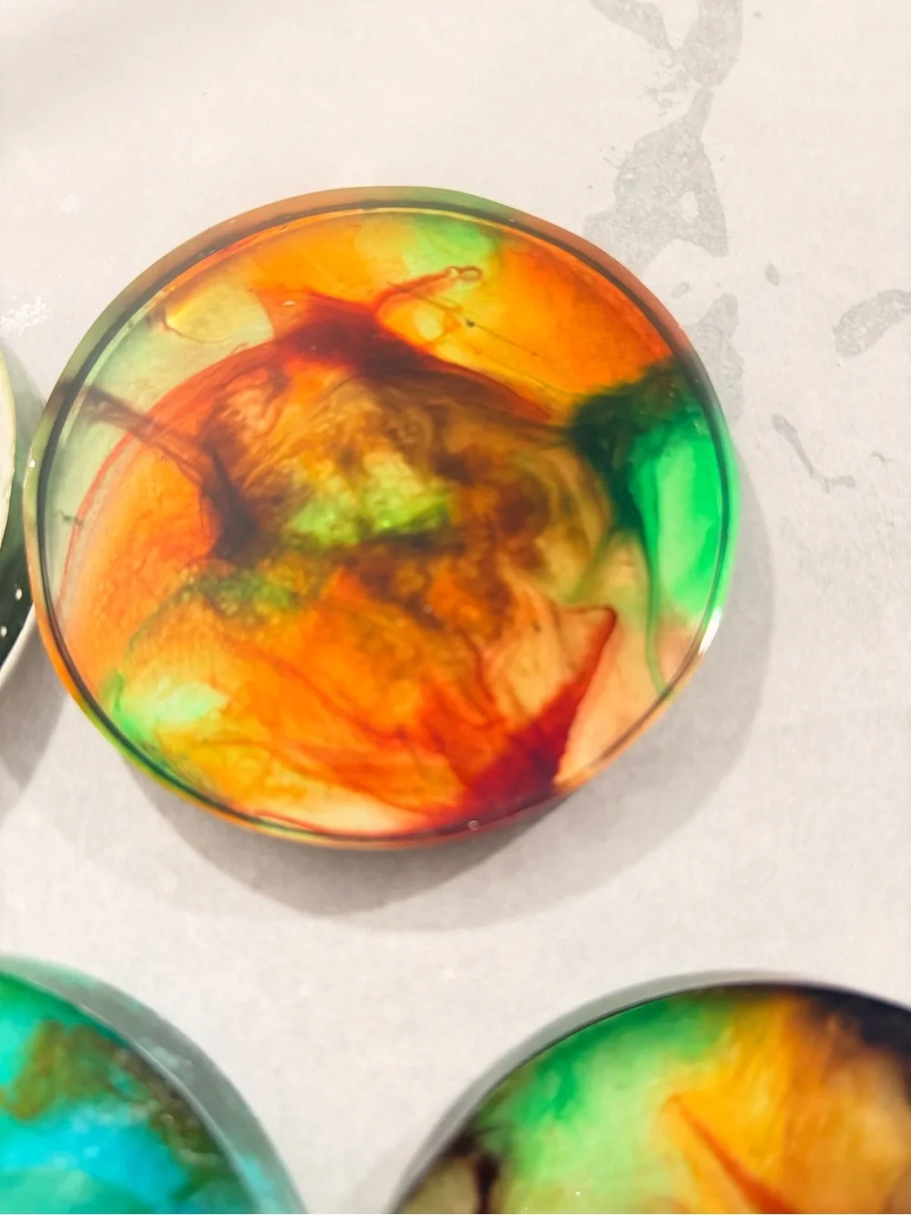 Handmade Resin Coaster with Swirl of Orange, Green and Red
